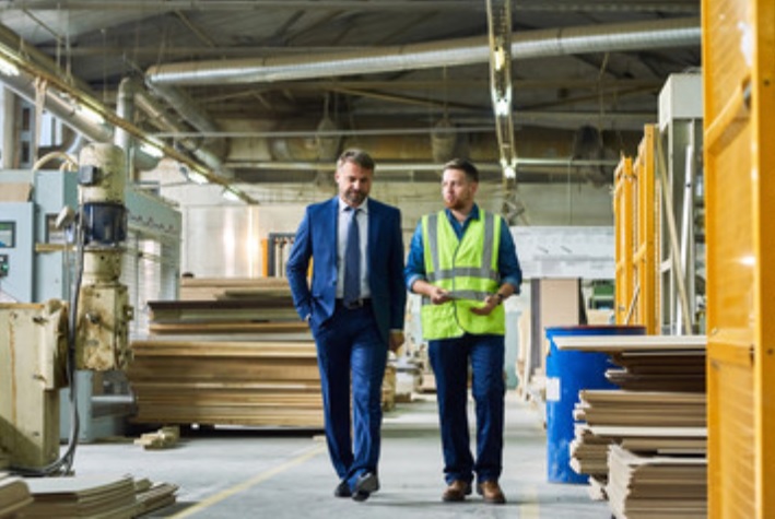 Image of two people walking through a warehouse